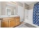 Well-maintained bathroom with a shower-tub combo and a classic vanity with ample storage at 132 E Morehouse Ave, Mooresville, NC 28117