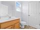 Bright bathroom featuring a wooden vanity, white countertop, and a window for natural light at 132 E Morehouse Ave, Mooresville, NC 28117