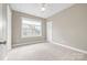 Bright bedroom with neutral walls, carpet, and a window with a view of the outdoors at 132 E Morehouse Ave, Mooresville, NC 28117