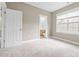 Bedroom with neutral walls, carpet and a view into a bathroom at 132 E Morehouse Ave, Mooresville, NC 28117