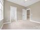 Bright bedroom features neutral walls, white trim, carpet flooring, and ceiling fan at 132 E Morehouse Ave, Mooresville, NC 28117