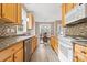 Galley kitchen with light wood cabinetry and granite countertops at 132 E Morehouse Ave, Mooresville, NC 28117