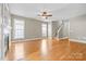 Spacious living room with fireplace, hardwood floors, and natural light from multiple windows at 132 E Morehouse Ave, Mooresville, NC 28117