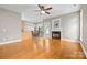 Open-concept living room flowing into kitchen with fireplace feature at 132 E Morehouse Ave, Mooresville, NC 28117