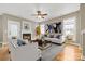 Staged living room offering ample seating, a fireplace, and neutral decor at 132 E Morehouse Ave, Mooresville, NC 28117