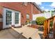 The backyard patio has sliding doors, a white fence, and lush greenery, perfect for outdoor enjoyment at 13838 Hill St, Huntersville, NC 28078