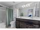Bathroom offers a shower-tub combo, sleek vanity with double sinks, and cabinet and drawers for storage at 13838 Hill St, Huntersville, NC 28078