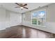 Bedroom boasts hardwood floors, ceiling fan, and a large double-door closet for ample storage at 13838 Hill St, Huntersville, NC 28078