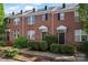Charming brick townhome with manicured landscaping, offering classic appeal and inviting curb appeal at 13838 Hill St, Huntersville, NC 28078