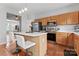 Lovely kitchen features an island with barstool seating, stainless steel appliances and wood flooring at 13838 Hill St, Huntersville, NC 28078
