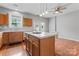 The eat-in kitchen has an island with bar seating and stainless steel sink at 13838 Hill St, Huntersville, NC 28078