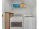 Convenient laundry room with washer, dryer, shelving and hanging rack for efficient organization at 13838 Hill St, Huntersville, NC 28078