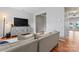 View of the open-concept living room featuring new wood floors and an entertainment center at 13838 Hill St, Huntersville, NC 28078