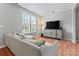 Comfortable living room with hardwood floors and a large window for natural light at 13838 Hill St, Huntersville, NC 28078