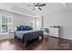 Spacious main bedroom with hardwood floors, tray ceilings, and plenty of light at 13838 Hill St, Huntersville, NC 28078