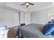 Bright main bedroom with hardwood floors, tray ceilings, ceiling fan, and two entry doors at 13838 Hill St, Huntersville, NC 28078