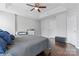 Comfortable main bedroom featuring hardwood floors, a ceiling fan, and tray ceilings at 13838 Hill St, Huntersville, NC 28078