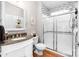 Updated bathroom featuring a glass enclosed shower, granite countertops, and hardwood floors at 143 Heywatchis Dr, Mooresville, NC 28115