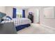 Bright bedroom with carpet, window with curtains, dresser with television, and white door at 143 Heywatchis Dr, Mooresville, NC 28115