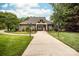 Linwood Farms clubhouse with a well-manicured lawn, flowers, and decorative lamp posts at 143 Heywatchis Dr, Mooresville, NC 28115