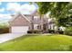 Charming two-story brick home featuring a well-manicured lawn and inviting curb appeal at 143 Heywatchis Dr, Mooresville, NC 28115