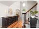 Bright foyer featuring hardwood floors, a staircase, and decor with views to the front door and living spaces at 143 Heywatchis Dr, Mooresville, NC 28115