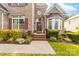 Charming brick home featuring a welcoming front entrance with a beautifully landscaped garden and a classic arched doorway at 143 Heywatchis Dr, Mooresville, NC 28115