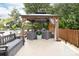 A cozy outdoor gazebo with comfortable seating and a fire pit, perfect for relaxing and entertaining at 143 Heywatchis Dr, Mooresville, NC 28115