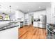 Well-lit kitchen features stainless steel appliances, white cabinetry, and dark countertops at 143 Heywatchis Dr, Mooresville, NC 28115