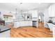 Bright, open kitchen boasts stainless steel appliances, white cabinets, and hardwood floors at 143 Heywatchis Dr, Mooresville, NC 28115