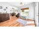 Open-concept living room features a comfortable chair, natural light, and hardwood flooring at 143 Heywatchis Dr, Mooresville, NC 28115