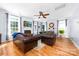 Cozy living room with hardwood floors, a fireplace, comfortable seating, and ample natural light at 143 Heywatchis Dr, Mooresville, NC 28115