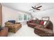 Attic living room featuring a brown sofa, patterned chair, carpet, and large window at 143 Heywatchis Dr, Mooresville, NC 28115