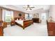 Spacious bedroom with a tray ceiling, natural light, and a large bed at 143 Heywatchis Dr, Mooresville, NC 28115