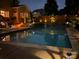 Beautifully lit pool at night featuring a waterfall and landscaping, creating a serene atmosphere at 143 Heywatchis Dr, Mooresville, NC 28115
