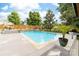 Relaxing in-ground pool featuring a stone waterfall feature and lots of space for outdoor furniture at 143 Heywatchis Dr, Mooresville, NC 28115