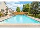 Beautiful in-ground pool featuring a stone waterfall, surrounded by landscaping, a patio, and decking at 143 Heywatchis Dr, Mooresville, NC 28115
