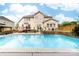 Backyard oasis featuring a large swimming pool, deck, and well-maintained landscaping at 143 Heywatchis Dr, Mooresville, NC 28115