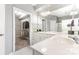 Bright bathroom features a large mirror, vanity with sink, and a walk-in closet for storage at 14857 Santa Lucia Dr, Charlotte, NC 28277