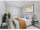 Neutral bedroom with soft decor, a picture window, and modern side tables and lighting at 14857 Santa Lucia Dr, Charlotte, NC 28277