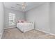 Neutral bedroom with a white daybed, ceiling fan, and window at 14857 Santa Lucia Dr, Charlotte, NC 28277