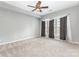 Carpeted bedroom with ceiling fan, and bright window with curtains for privacy at 14857 Santa Lucia Dr, Charlotte, NC 28277