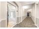 Hallway with carpet and neutral paint leading to various rooms at 14857 Santa Lucia Dr, Charlotte, NC 28277
