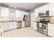 Bright kitchen features stainless steel appliances, ample white cabinetry, and neutral countertops at 14857 Santa Lucia Dr, Charlotte, NC 28277