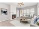 Bright living room features a fireplace, three windows, and a comfortable couch with stylish pillows at 14857 Santa Lucia Dr, Charlotte, NC 28277
