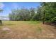 Large backyard featuring well maintained lawn and dense, mature trees at 153 Mills Garden Rd, Statesville, NC 28625