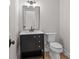 Chic powder room features a sleek black vanity, stylish fixtures, and ample lighting at 153 Mills Garden Rd, Statesville, NC 28625