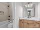 Modern bathroom featuring dual vanity with white countertops, wooden cabinets, and a bathtub at 153 Mills Garden Rd, Statesville, NC 28625