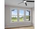 Bright bedroom boasts three windows offering stunning outdoor views and a ceiling fan at 153 Mills Garden Rd, Statesville, NC 28625