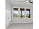 Bedroom with a ceiling fan and large windows offering wooded backyard views at 153 Mills Garden Rd, Statesville, NC 28625